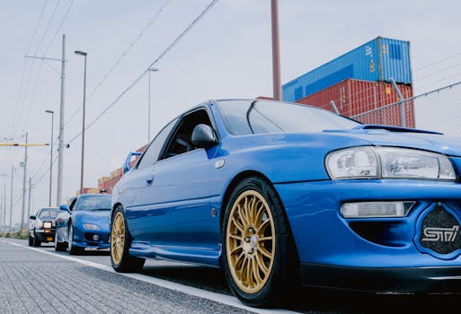 A lineup of vibrant Japanese cars parked on a city street, showcasing their sleek designs.